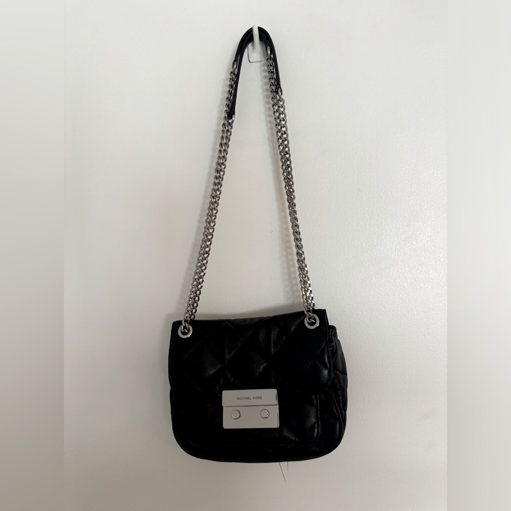 Double strap black purse with metal strap detail and locking metal clasp.